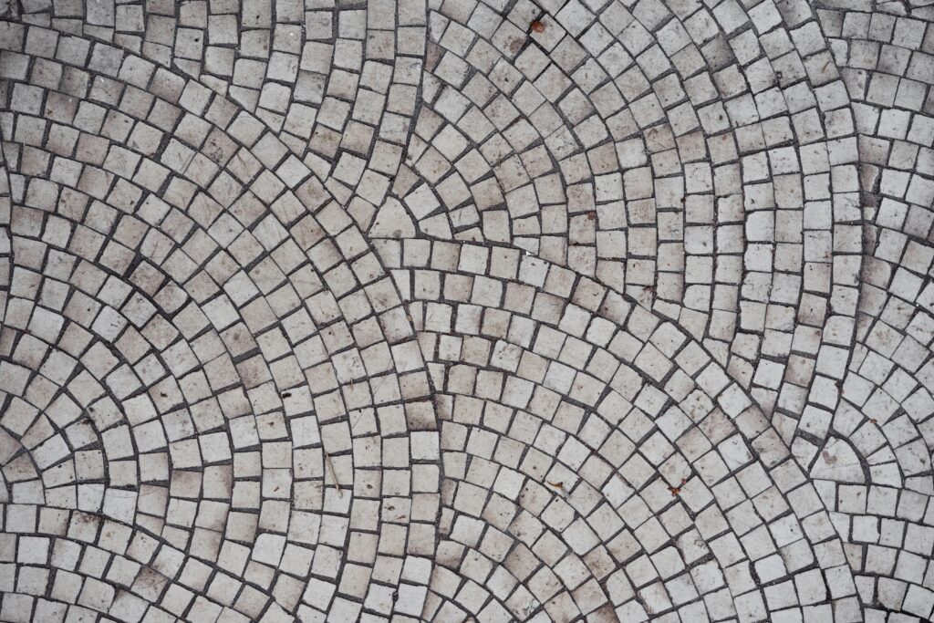 pexels photo 7245527 7245527 Detailed view of a geometric mosaic tile pattern with circular designs creating an artistic pavement.